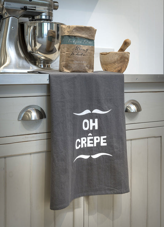 Oh crepe funny slogan tea towels are the perfect gift for anyone with a sense of humour! Made from flour sacking these tea towels come in grey with white print and a corner hanging tab. Perfect home accessory gift idea. Perfect in any kitchen and for anyone who can see the funny side.