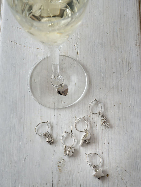 Our beautiful wine glass charms are perfect party tableware.  Pretty wine glass charms for party guests. Each is dainty, pretty and great when entertaining. Each set includes 6 different silver wine glass charms. Perfect gift for the wine lover. Be the perfect party host with our set of 6 silver wine glass charms.