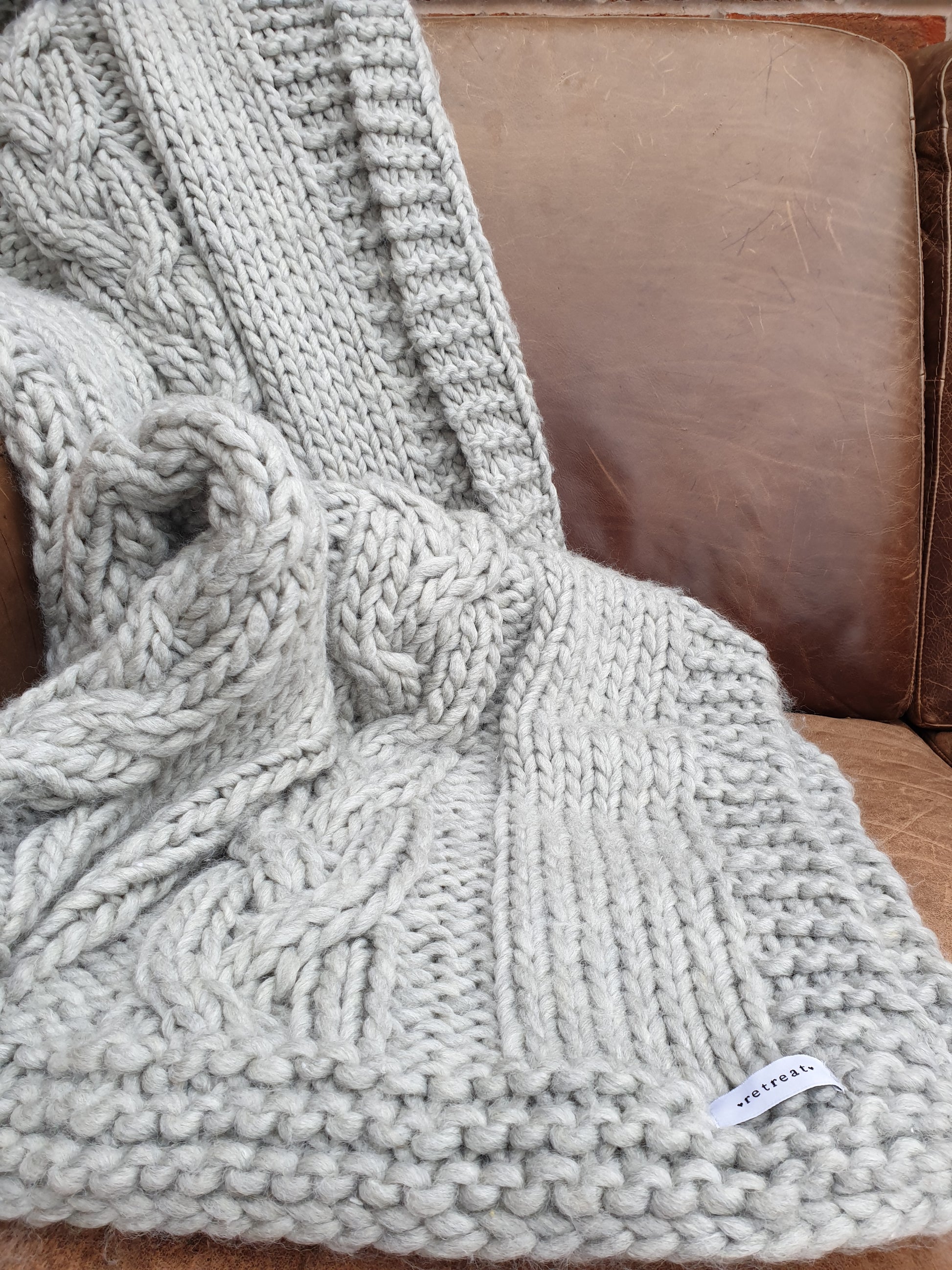 Chunky Knit Throw Blanket draped on sofa