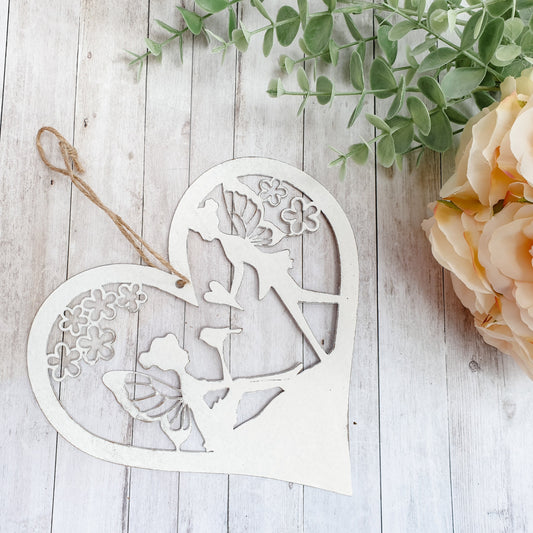 Fairy heart hanger. Metal hanging heart with fairy scene in centre. Beautiful garden decoration for fairy gardens.  add magic to your garden wwithour hanging fairy scene heart.  pretty whie hanging decoration for the garden. Perfect gift for grandchildren, nieces, nephews, sons and daughters - creating a magical garden for all the family to enjoy.