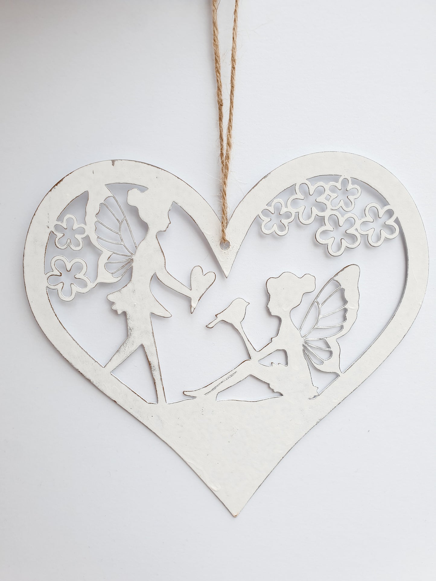 Fairy heart hanger. Metal hanging heart with fairy scene in centre. Beautiful garden decoration for fairy gardens. add magic to your garden wwithour hanging fairy scene heart. pretty whie hanging decoration for the garden. Perfect gift for grandchildren, nieces, nephews, sons and daughters - creating a magical garden for all the family to enjoy.