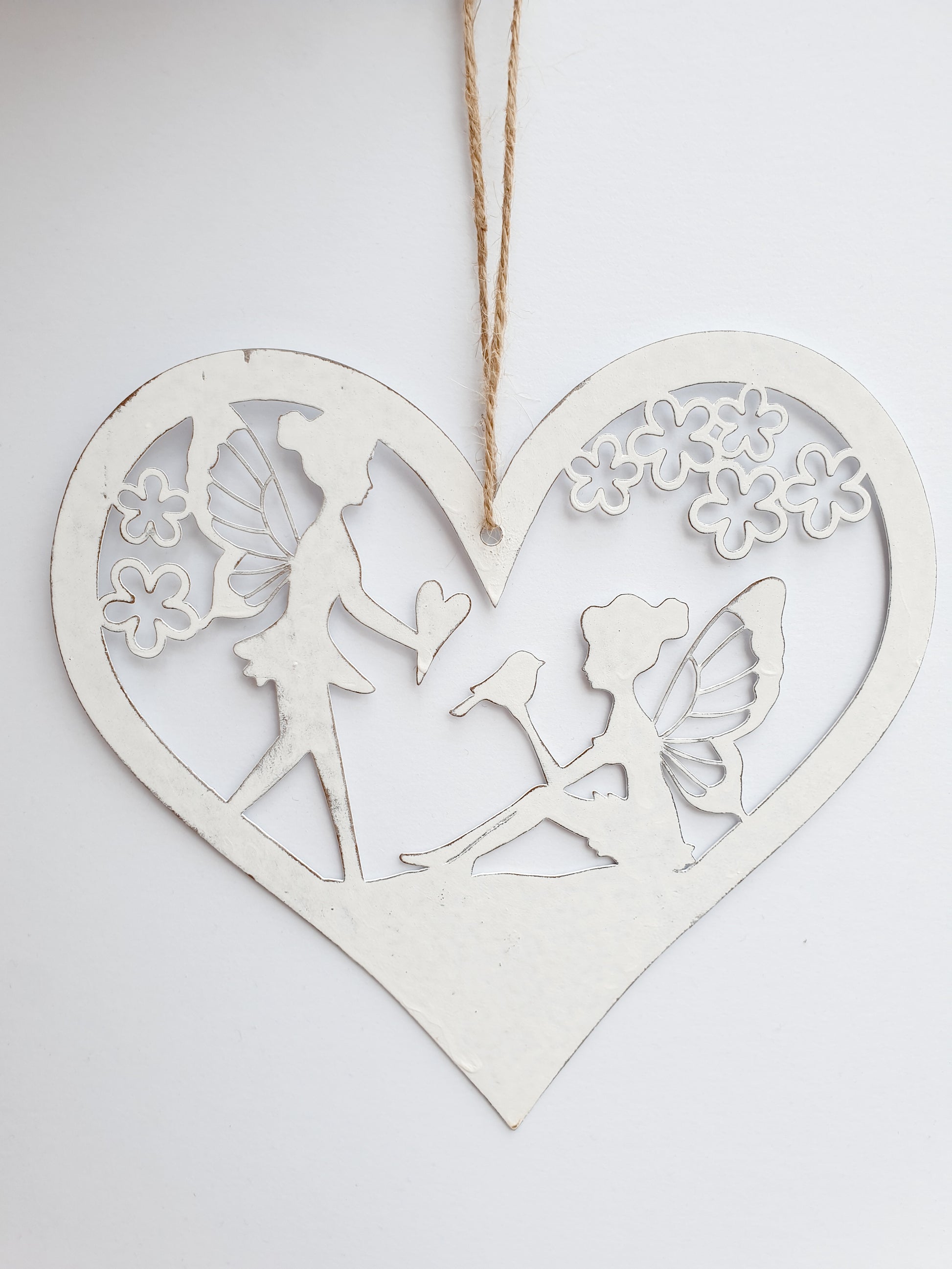 Fairy heart hanger. Metal hanging heart with fairy scene in centre. Beautiful garden decoration for fairy gardens. add magic to your garden wwithour hanging fairy scene heart. pretty whie hanging decoration for the garden. Perfect gift for grandchildren, nieces, nephews, sons and daughters - creating a magical garden for all the family to enjoy.