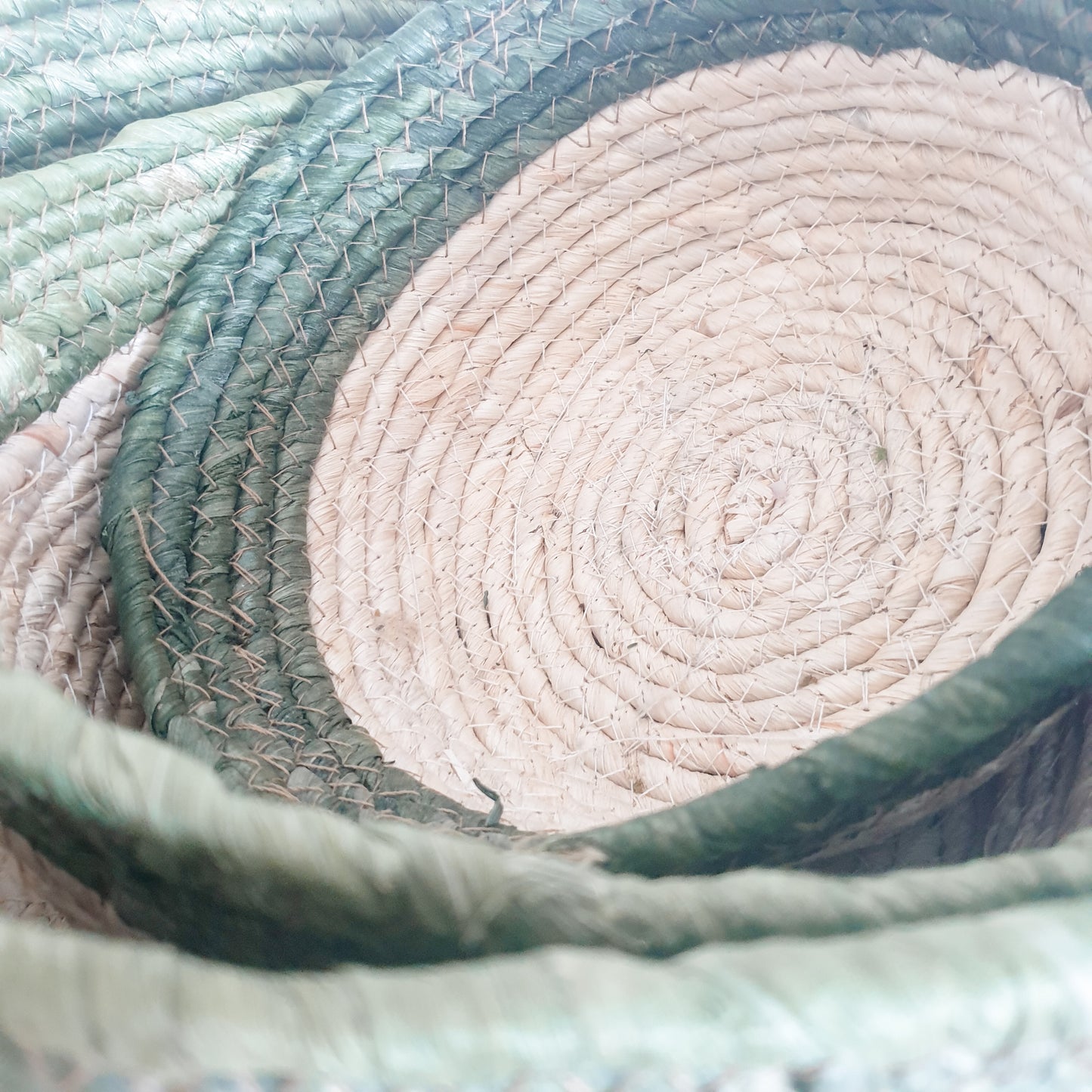 Close up detail of Set of three olive trimmed straw baskets, perfect for adding natural texture and rustic touches to your home interiors