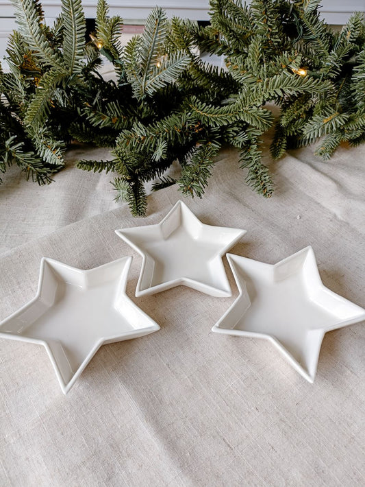 Set of 3 dips or trinket dishes. White ceramic star dishes shown with Christmas foliage
