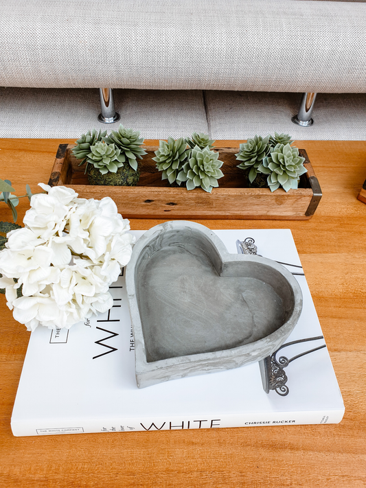 grey cement heart shaped tray with hydrangea and faux succulents in rustic wooden trays
