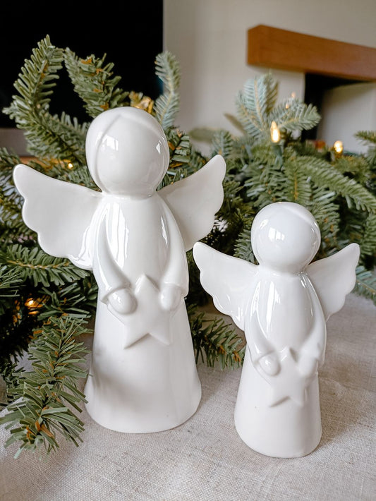 Pair of white ceramic angels holding stars | Christmas windowsill decor