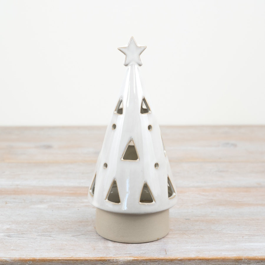 Large White LED ceramic Christmas tree with star on top on a wooden surface