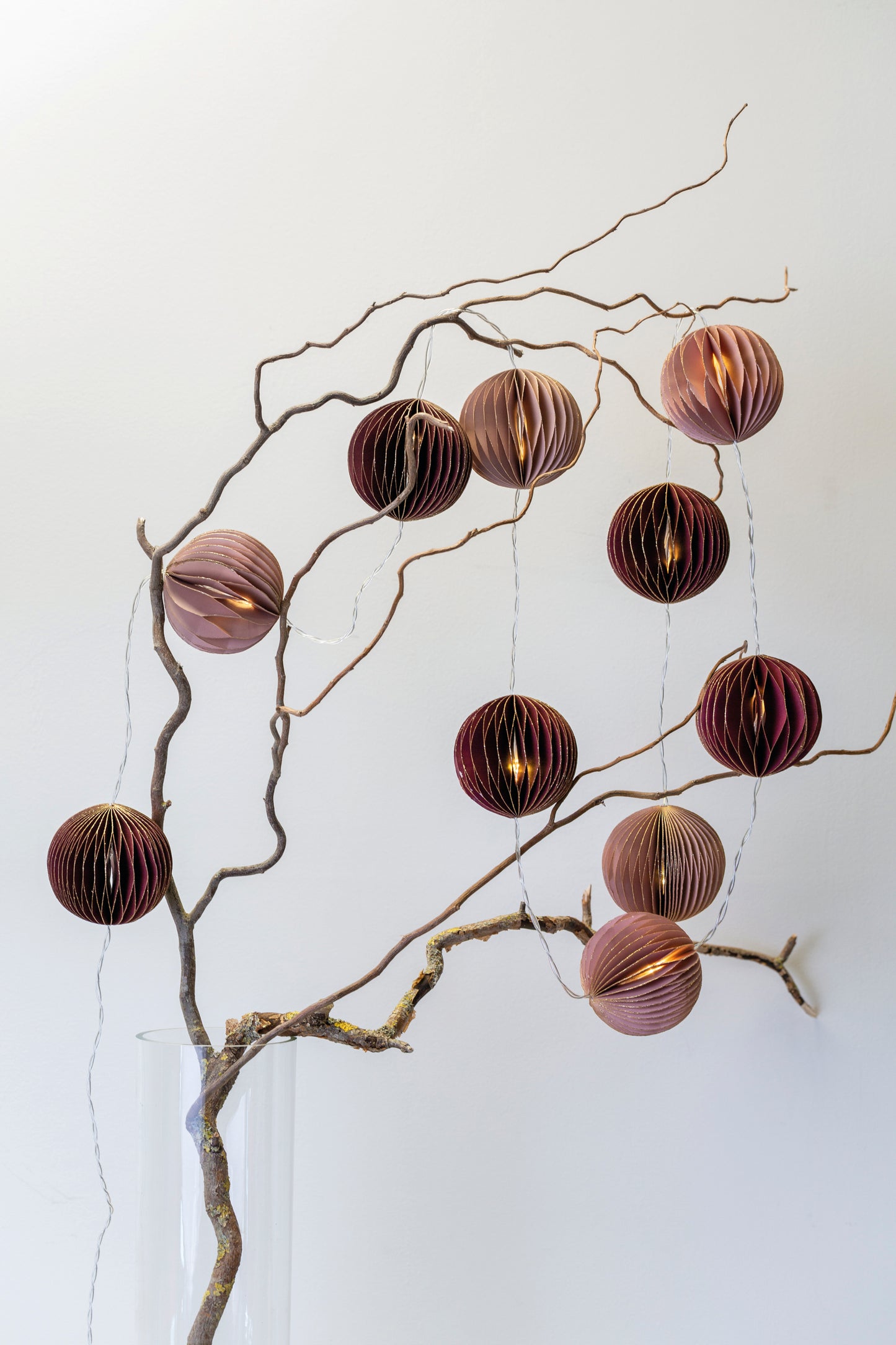 Dusky Pink and Warm Wine tones combine on this luxury honeycomb paper decoration garland with LED fairy lights on a timer from Little Wren Interiors