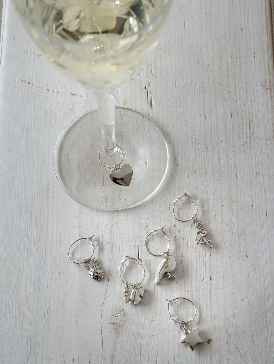 Our beautiful wine glass charms are perfect party tableware.  Pretty wine glass charms for party guests. Each is dainty, pretty and great when entertaining. Each set includes 6 different silver wine glass charms. Perfect gift for the wine lover. Be the perfect party host with our set of 6 silver wine glass charms.