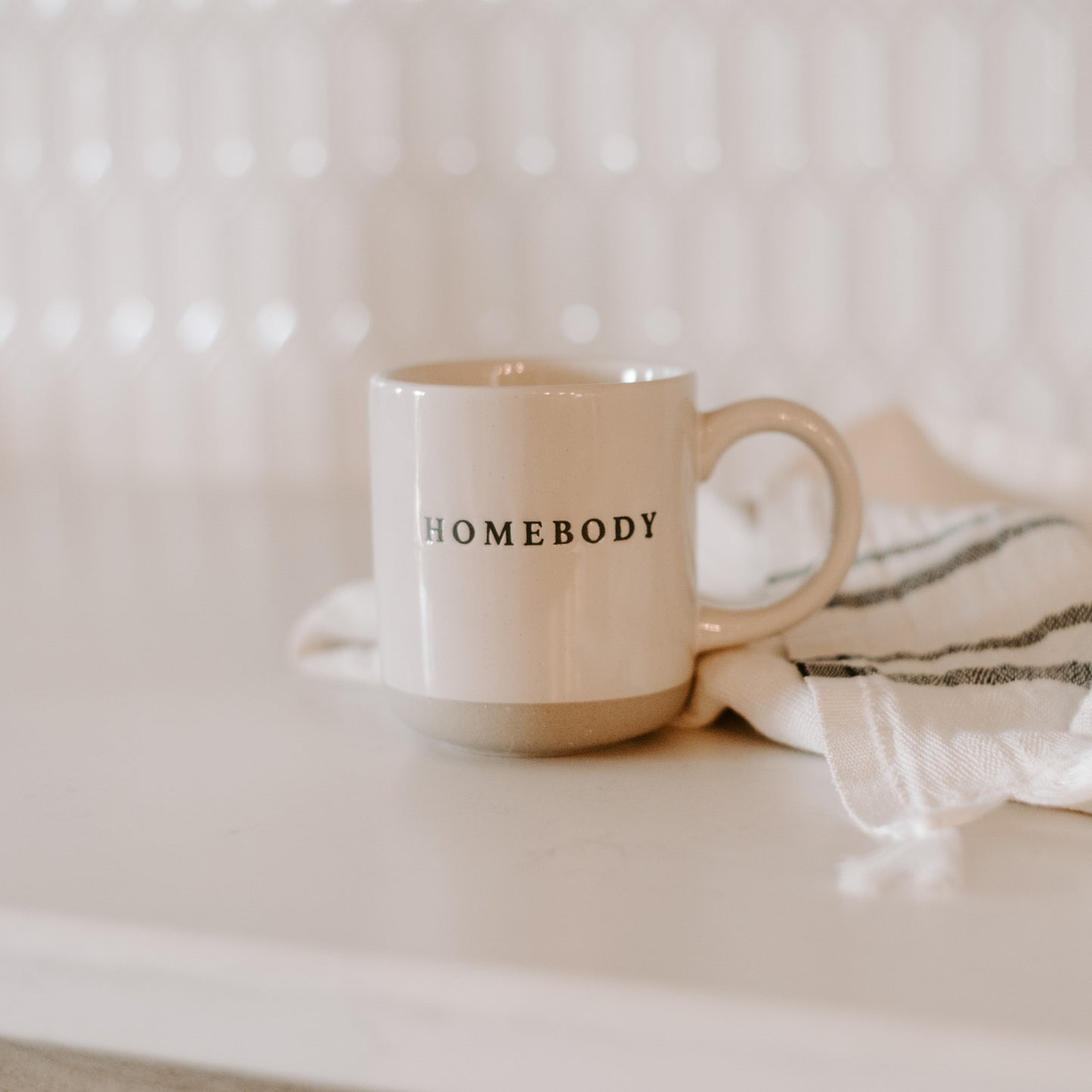 Pretty homebody mug in the style loved by Stacey Solomon.  Pour morning coffee into stoneware homebody mug. Perfect gift for home decor and interiors lovers. Embossed homebody lettering on pretty home mug. Gift for tea drinker, hot choclate lover or coffee addict alike. Homebody mug is a partglazed stoneware mug. Makes an ideal mug gift for home lovers
