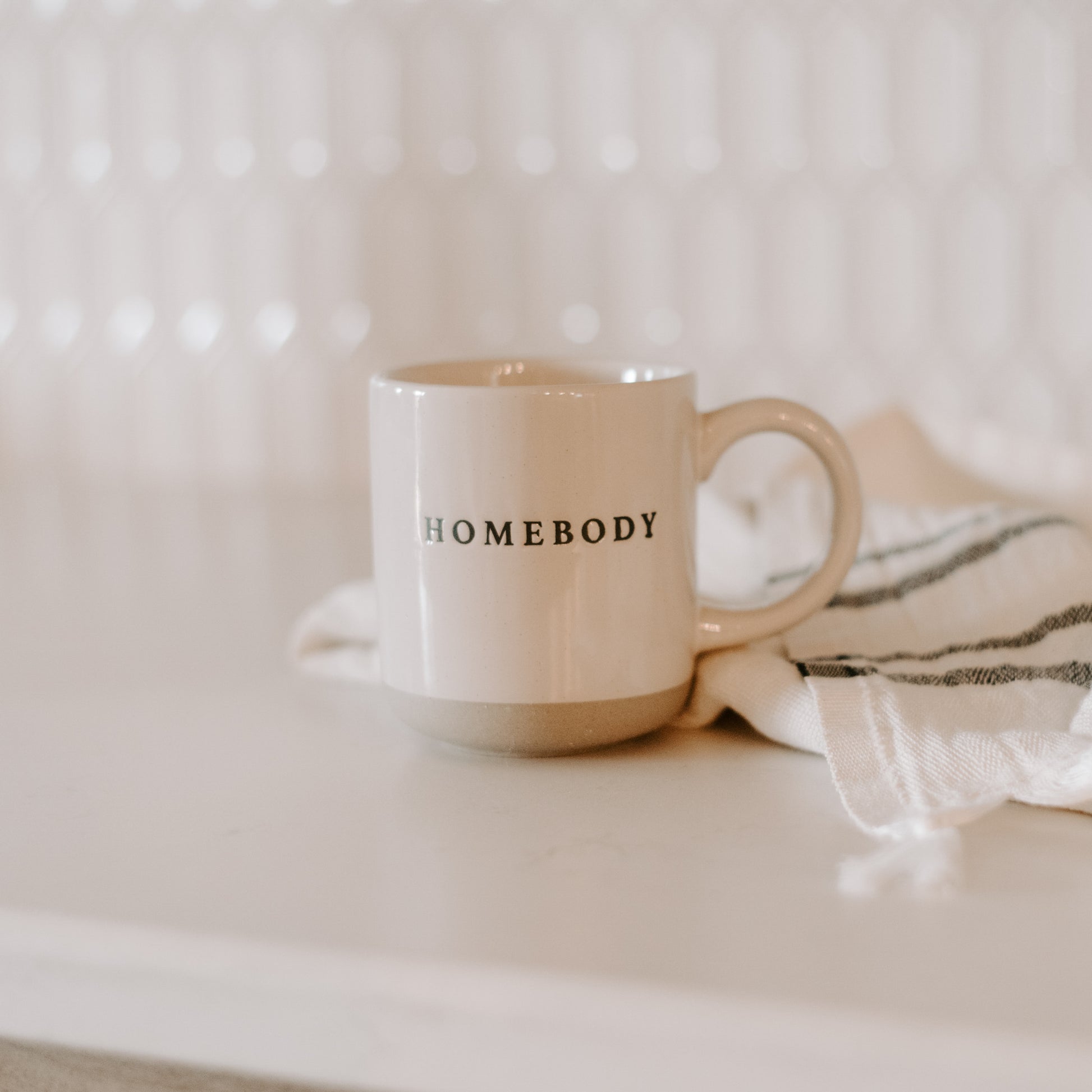 Pretty homebody mug in the style loved by Stacey Solomon.  Pour morning coffee into stoneware homebody mug. Perfect gift for home decor and interiors lovers. Embossed homebody lettering on pretty home mug. Gift for tea drinker, hot choclate lover or coffee addict alike. Homebody mug is a partglazed stoneware mug. Makes an ideal mug gift for home lovers