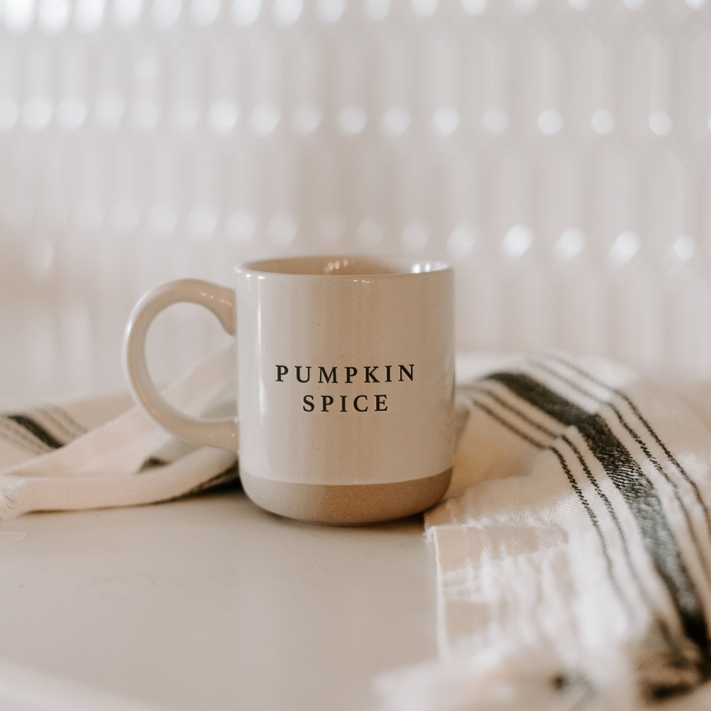 Pumpkin Spice mug on worktop with ticking strip cloth. Perfect autumnal gift for neutral and natural tones home decor. 