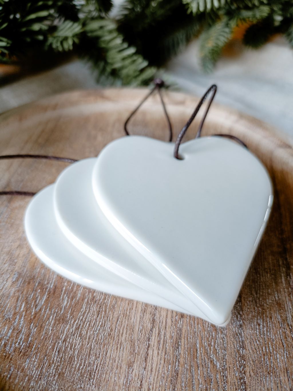 Stacked view of medium hanging heart decorations to show glaze detail