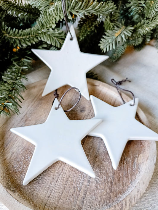 Detail view of hanging white ceramic star decorations